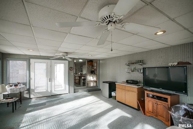 carpeted living room with french doors and ceiling fan