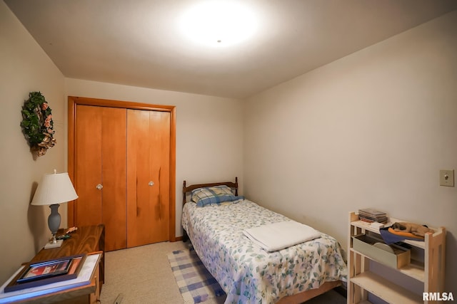 bedroom featuring light carpet and a closet