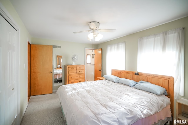 bedroom with light carpet, a closet, and ceiling fan