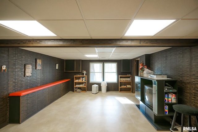 basement with a paneled ceiling