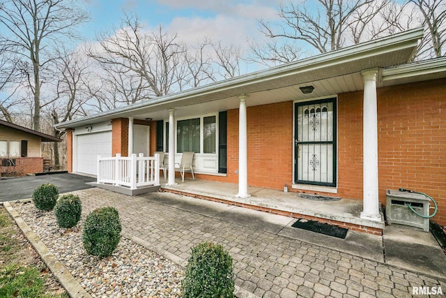 view of front of property with a porch and a garage