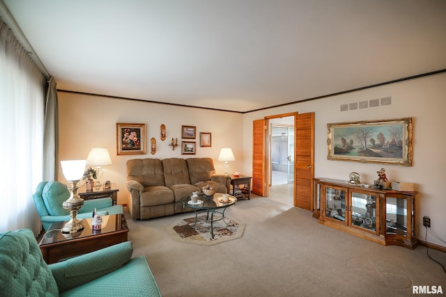 carpeted living room with ornamental molding