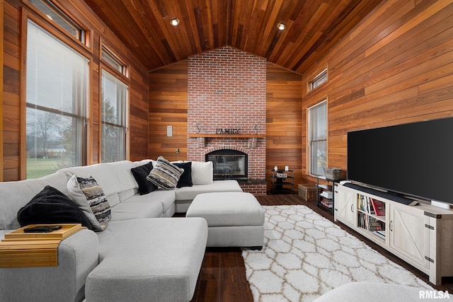 living room with dark hardwood / wood-style floors, wooden ceiling, wooden walls, and a brick fireplace