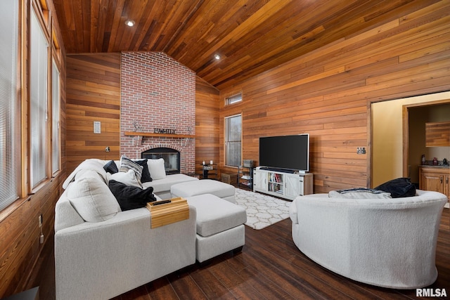 living room featuring lofted ceiling, dark wood-type flooring, wooden walls, a fireplace, and wood ceiling