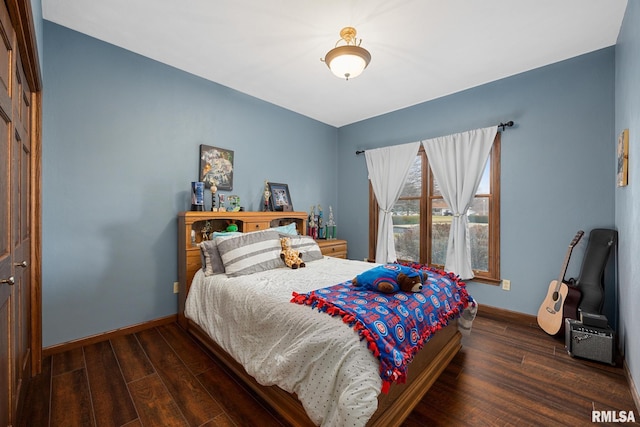 bedroom with dark wood-type flooring and a closet