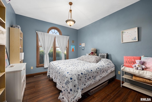 bedroom with dark wood-type flooring