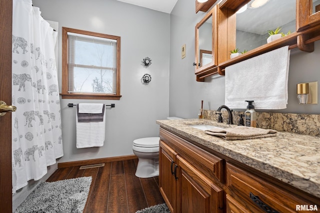 bathroom with vanity, hardwood / wood-style flooring, toilet, and heating unit