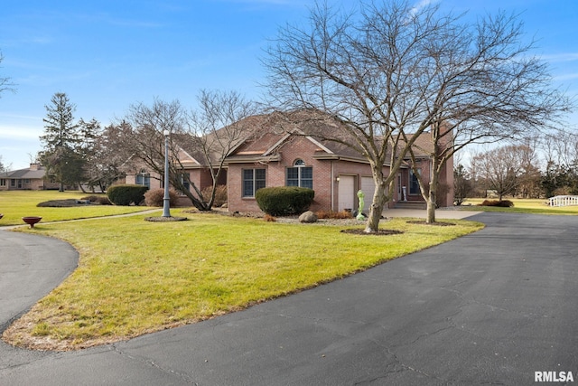 ranch-style home with a garage and a front yard