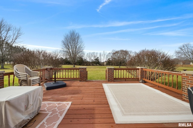 wooden deck featuring a yard