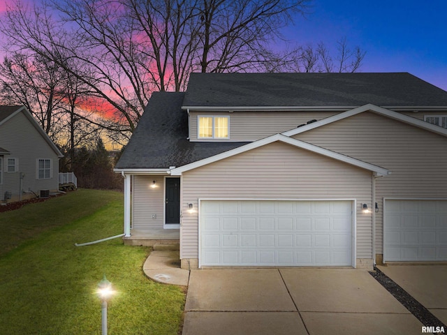 view of front of house with a yard and a garage