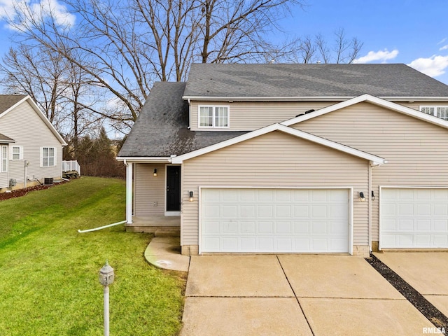 view of front of property with central AC, a garage, and a front lawn