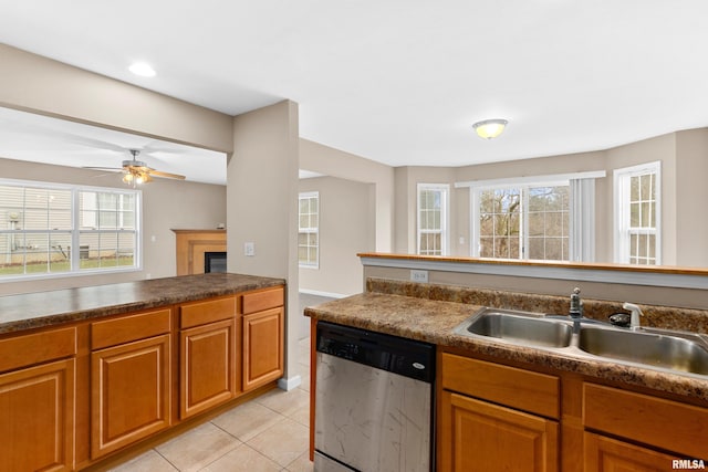 kitchen with light tile patterned floors, stainless steel dishwasher, ceiling fan, and sink