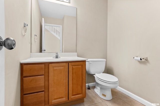 bathroom featuring tile patterned floors, vanity, and toilet