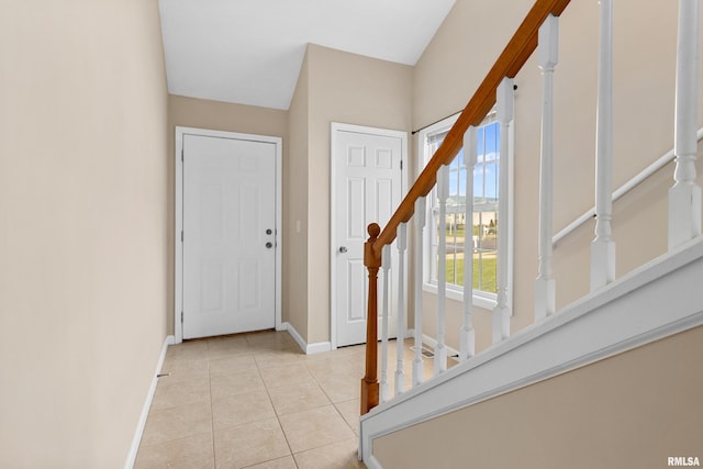 foyer entrance with light tile patterned floors