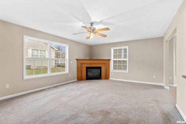 unfurnished living room with light carpet and ceiling fan