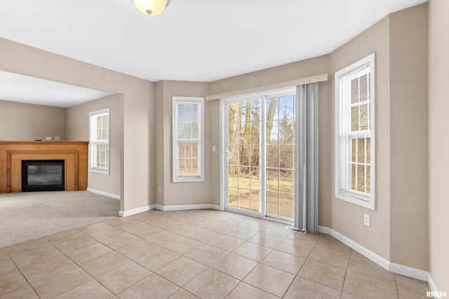 unfurnished living room with light tile patterned floors