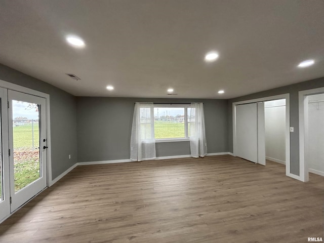 unfurnished bedroom featuring light wood-type flooring and access to outside