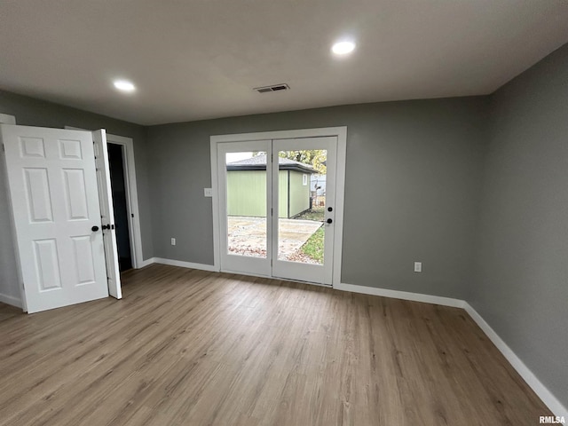 spare room with light hardwood / wood-style flooring