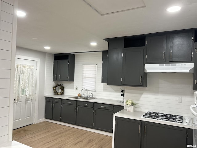 kitchen featuring light hardwood / wood-style floors, white gas stovetop, and sink