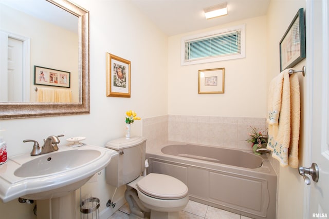 bathroom featuring tile patterned flooring, a bath, toilet, and sink