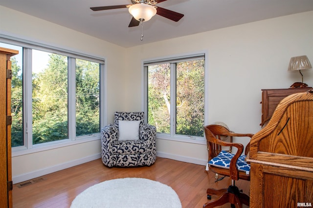 sitting room with light hardwood / wood-style floors and ceiling fan