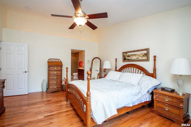 bedroom with ensuite bathroom, ceiling fan, and light hardwood / wood-style floors