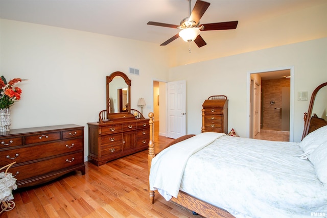 bedroom featuring ceiling fan, ensuite bathroom, and light hardwood / wood-style floors