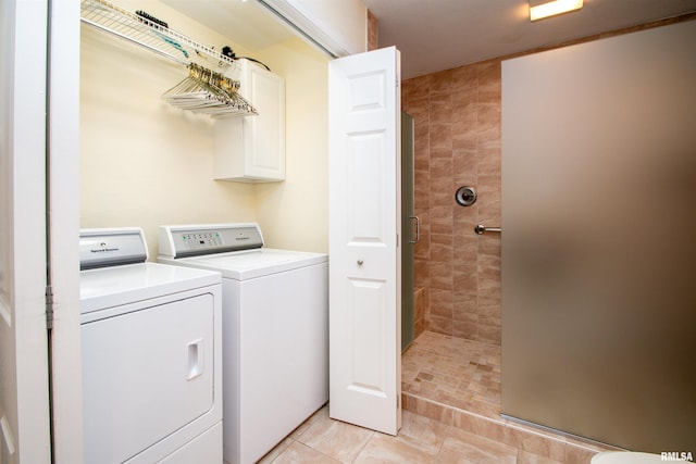 laundry room with light tile patterned floors and washer and clothes dryer