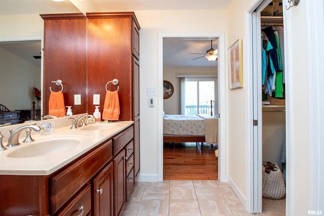 bathroom featuring tile patterned flooring, vanity, and ceiling fan