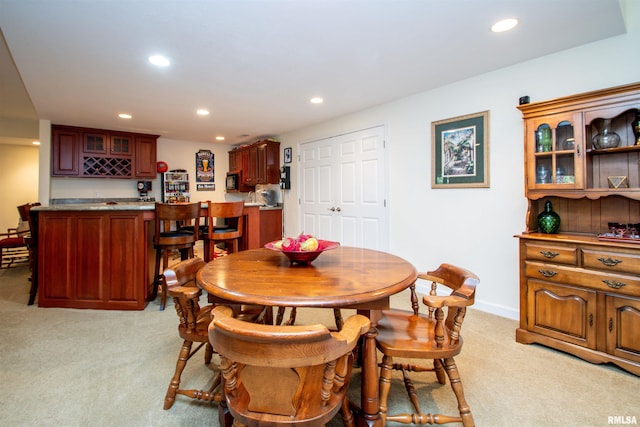 carpeted dining space with bar