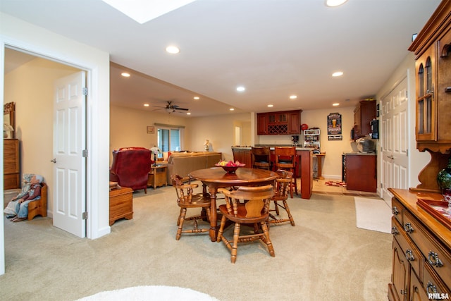 carpeted dining area with ceiling fan and indoor bar