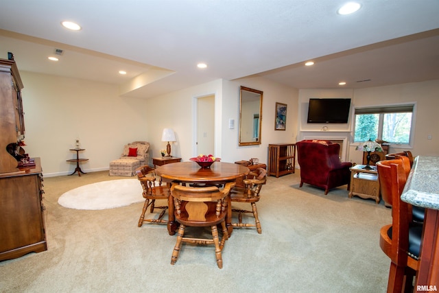 dining space featuring light carpet