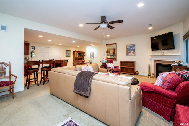 carpeted living room featuring ceiling fan