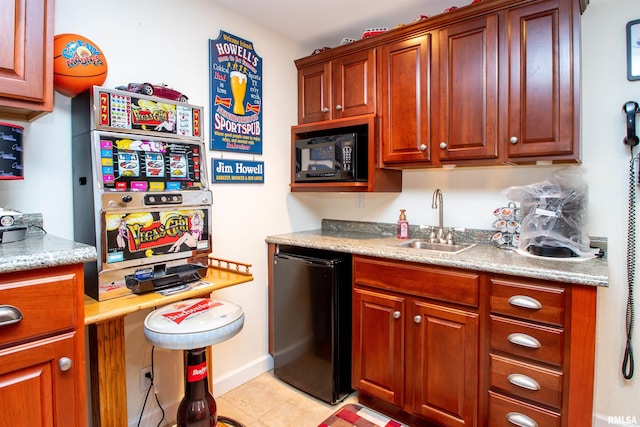 kitchen featuring light tile patterned floors, sink, and fridge