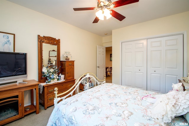 bedroom featuring ceiling fan, a closet, and light carpet