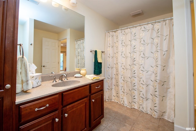 bathroom featuring tile patterned flooring and vanity