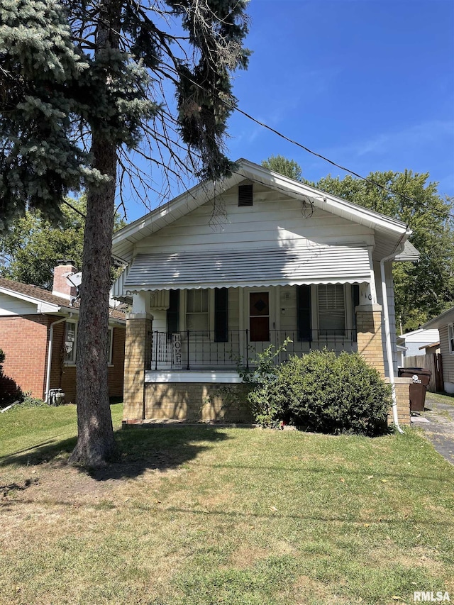 view of front of home with a porch and a front lawn