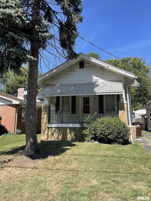 1101 E Melbourne Ave, Peoria, IL 61603 - view of front facade featuring a front yard, covered porch, and brick siding