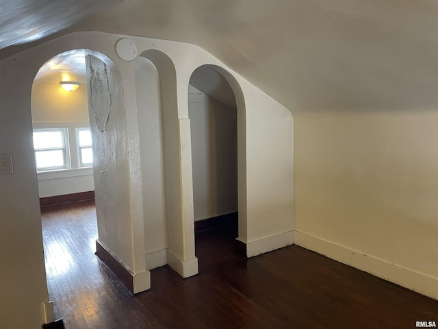 bonus room featuring dark hardwood / wood-style flooring and vaulted ceiling