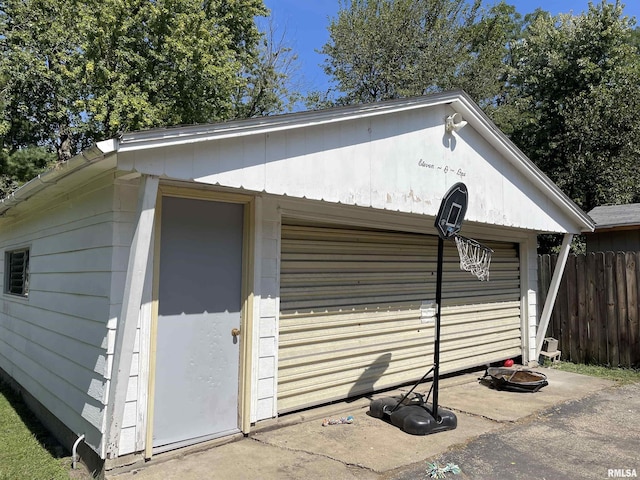 view of property exterior featuring an outbuilding and a garage