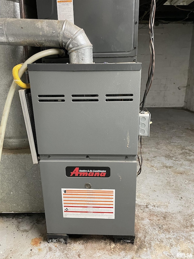 utility room featuring heating unit