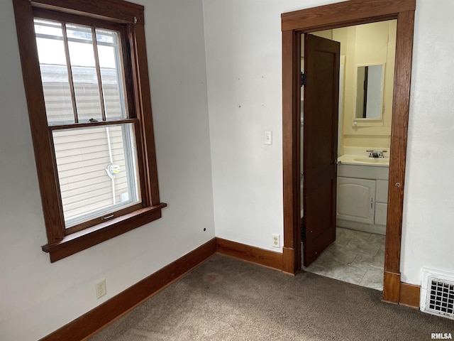 carpeted empty room with sink