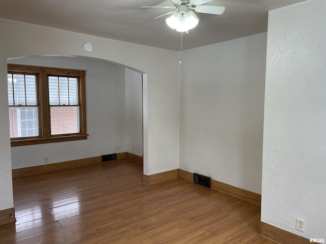 empty room featuring wood-type flooring and ceiling fan