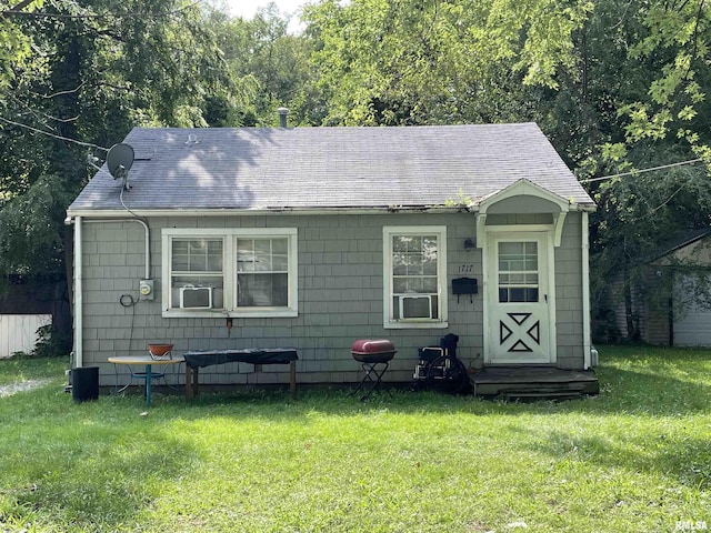 bungalow-style home with a front yard