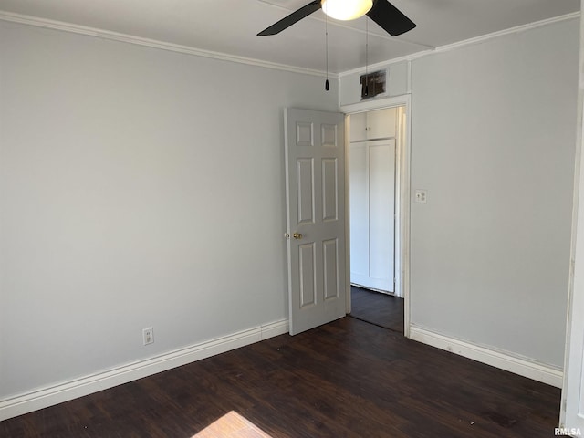 empty room with dark hardwood / wood-style floors, ceiling fan, and crown molding