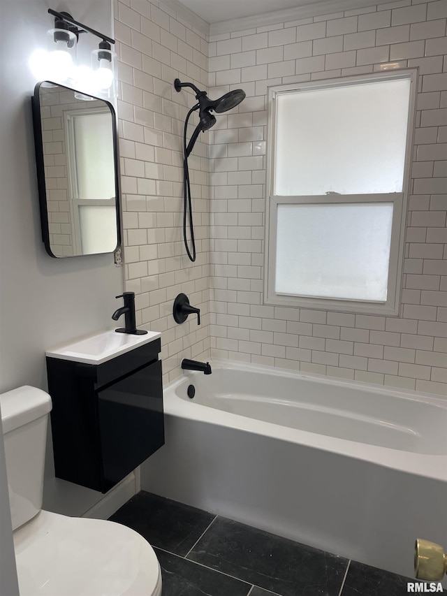 full bathroom with tile patterned flooring, vanity, tiled shower / bath combo, and toilet