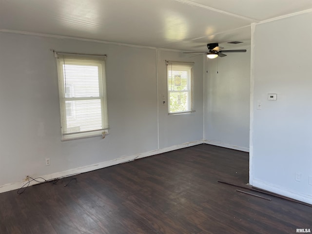 spare room featuring a wealth of natural light, dark hardwood / wood-style flooring, and ceiling fan