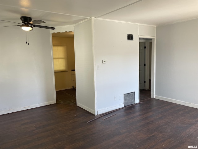 empty room featuring dark hardwood / wood-style floors and ceiling fan