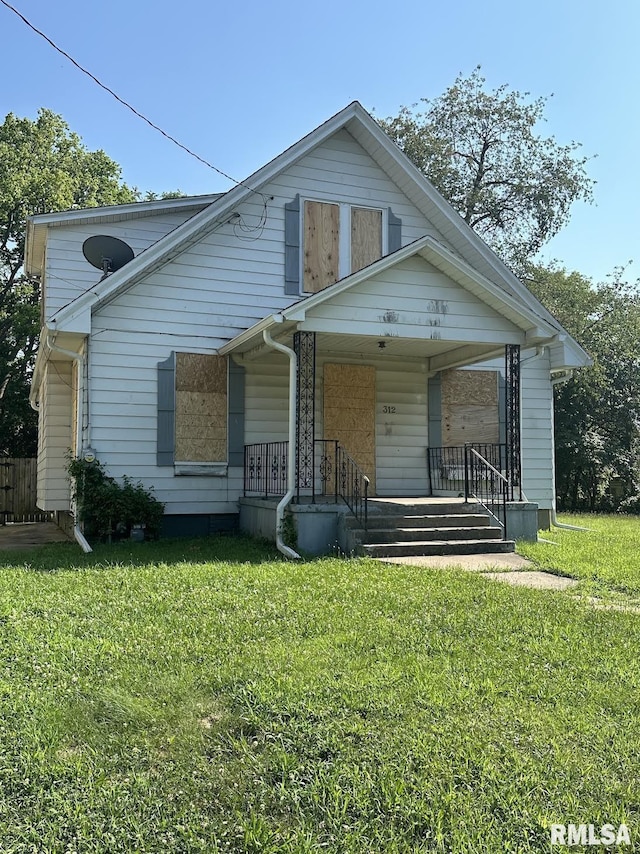 bungalow-style house featuring a porch and a front lawn