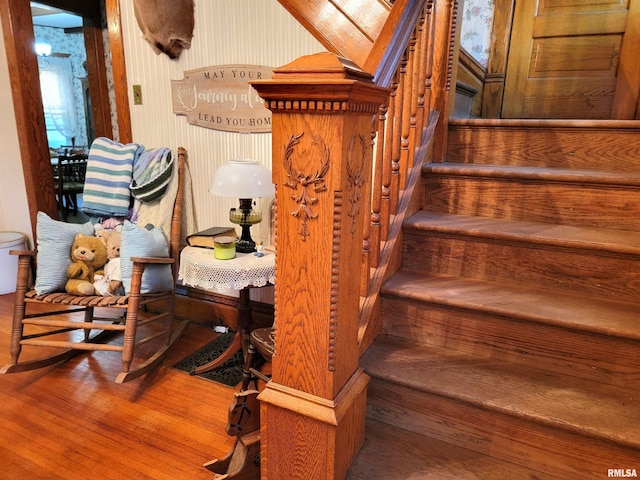 staircase with hardwood / wood-style floors